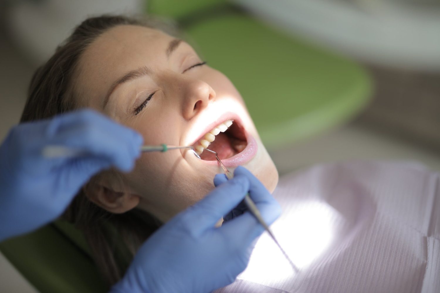 Dentist performing a dental procedure on a patient in scientific dental clinic